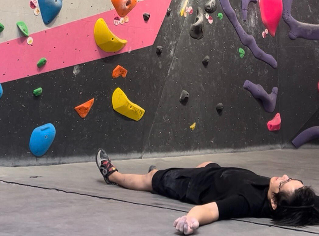 Ded. Lying flat on the gym mat at a Boulder Movement gym